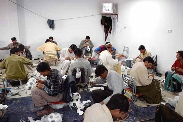 Hand stitching soccer ball panels by skilled workers for strong and durable finish